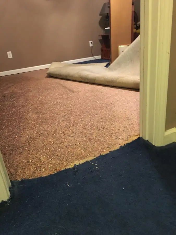 Carpet pad removal revealing water damage during Drying & Dehumidification in Clearlake